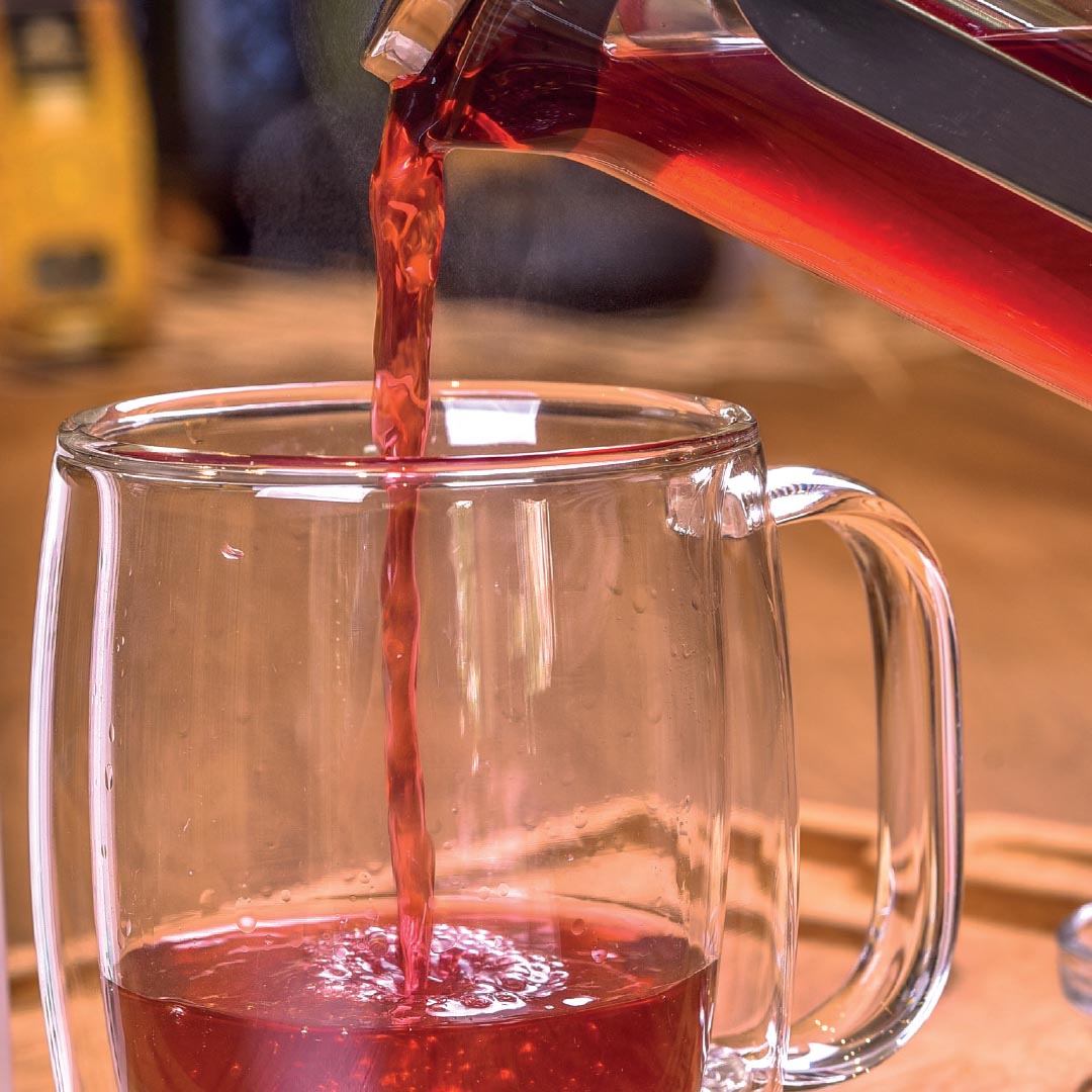 Colorful herbal and fruit tea infusions with dried botanicals